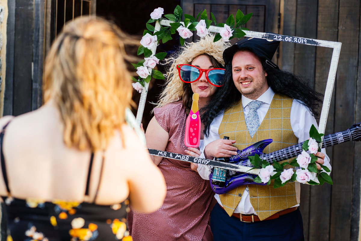 wedding guests having fun with Photo Booth props
