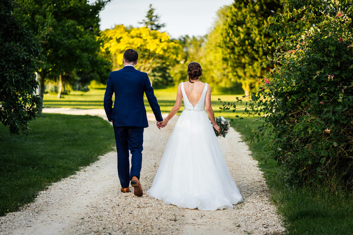 bride and groom walking holding hands