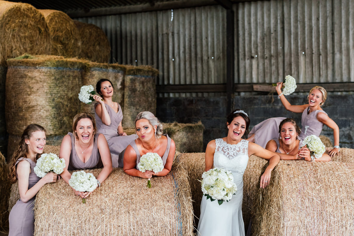 Bridesmaids group photo in the farm building