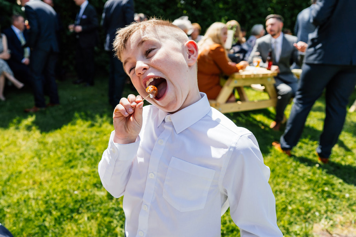 boy at wedding enjoying the canapés