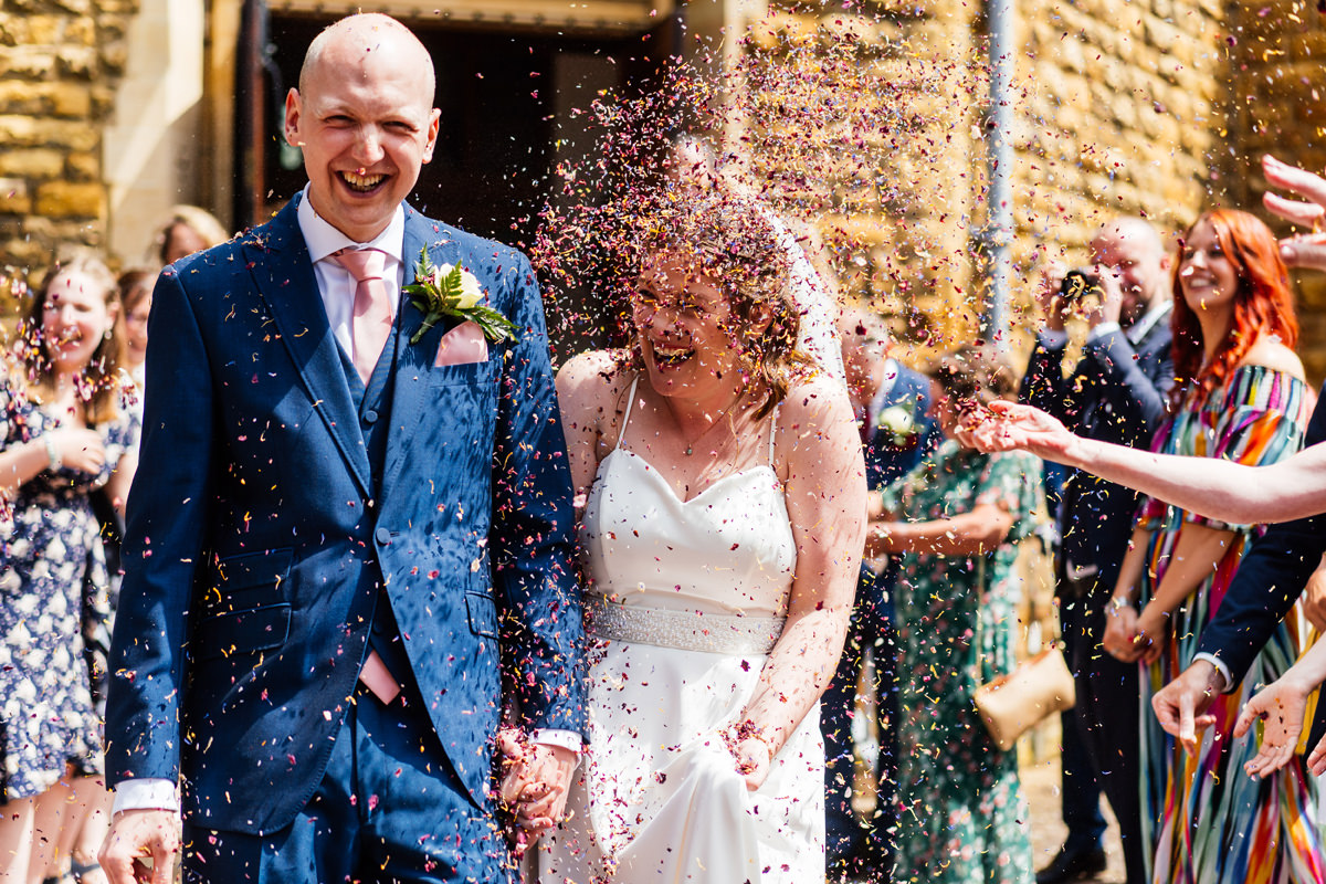 bride gets pelted with confetti