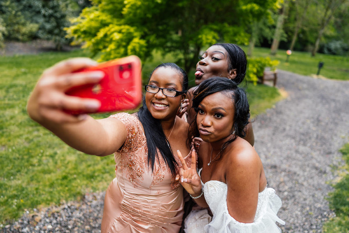 bride and guests doing a selfie on their phone