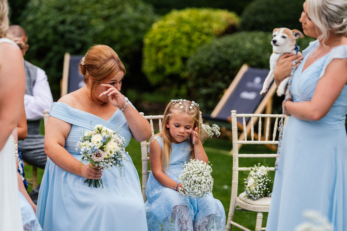bridesmaid and flower girl wipe a tear