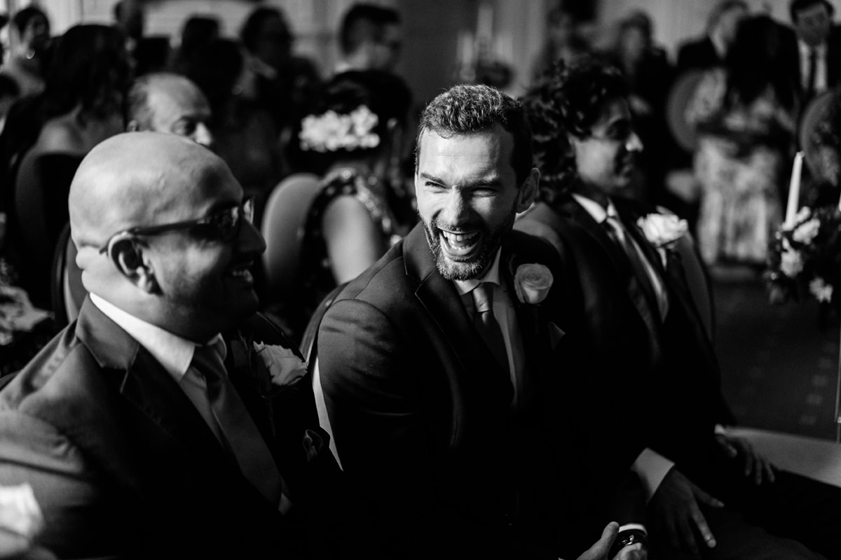 groomsmen laughing before marriage ceremony