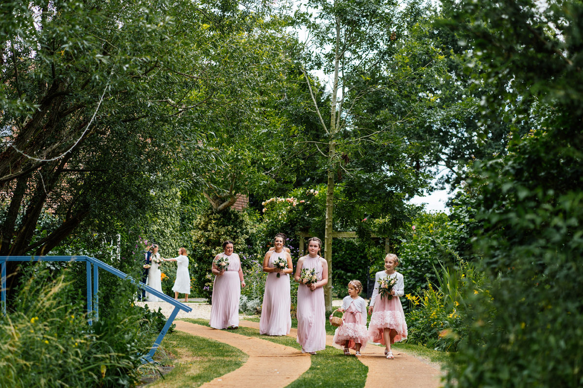 Flower girls and bridesmaids walking to the ceremony
