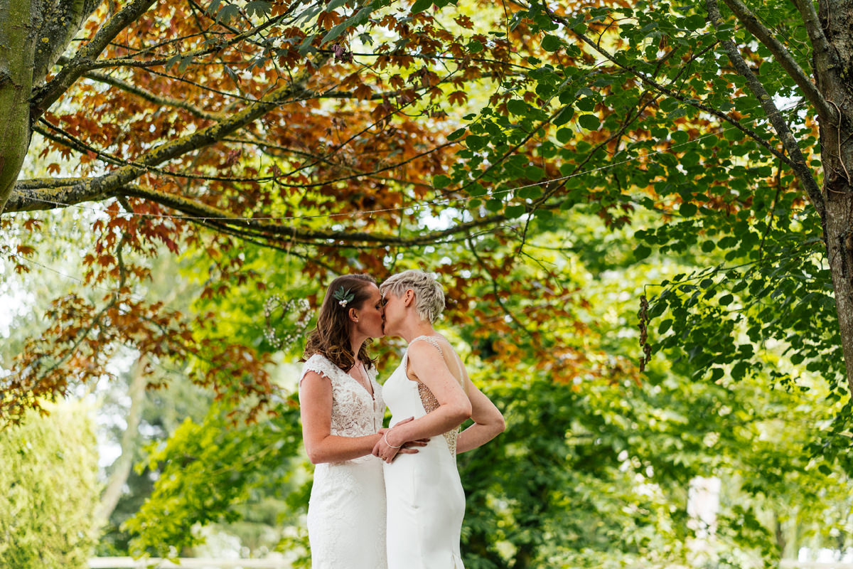 Brides have their first kiss at the end of the ceremony