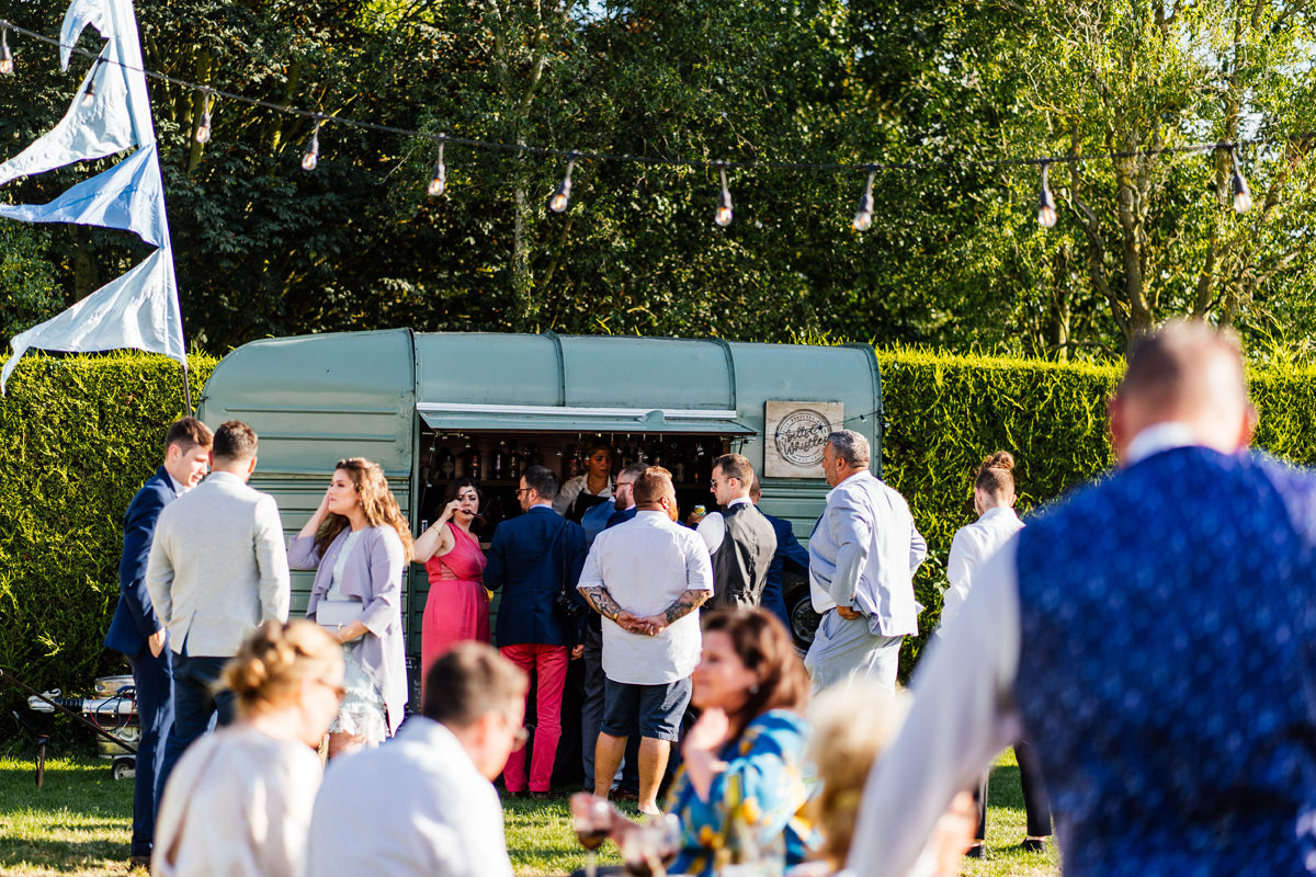 Guests getting drinks from converted horse box bar