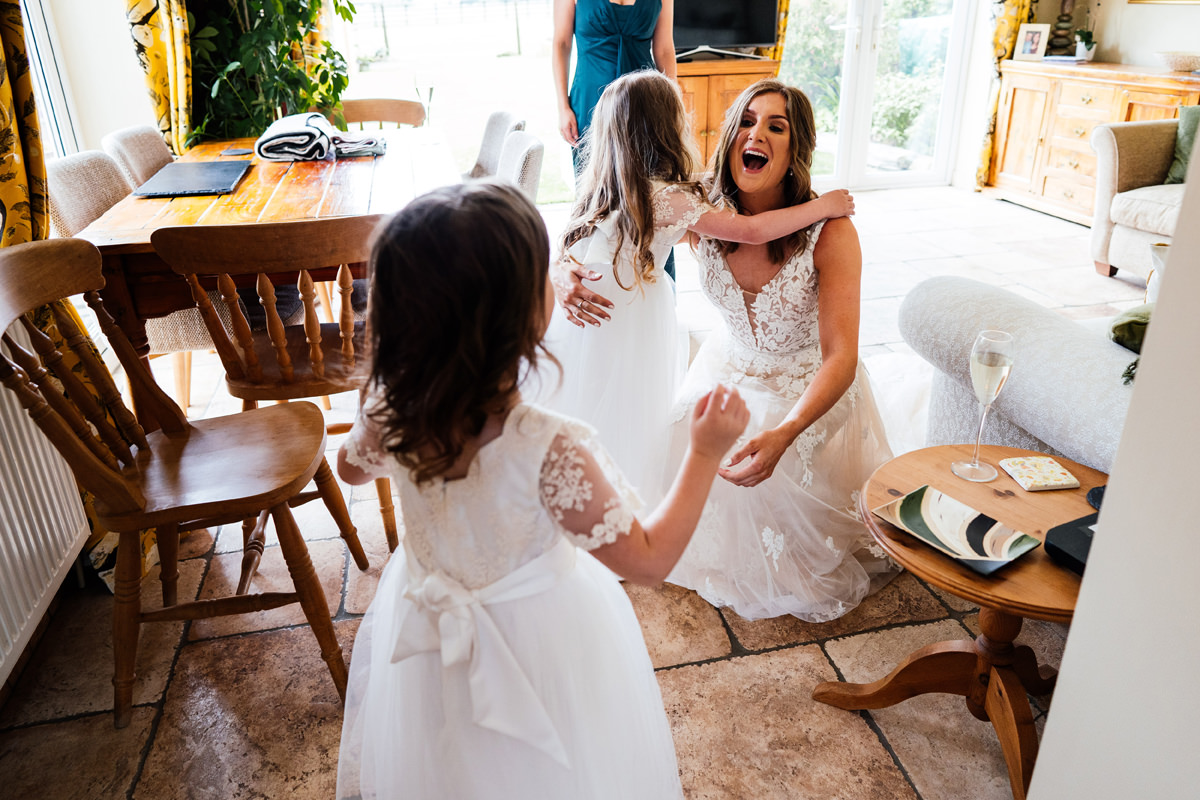 Bride sees her bridesmaids for the first time in their bridesmaids dresses