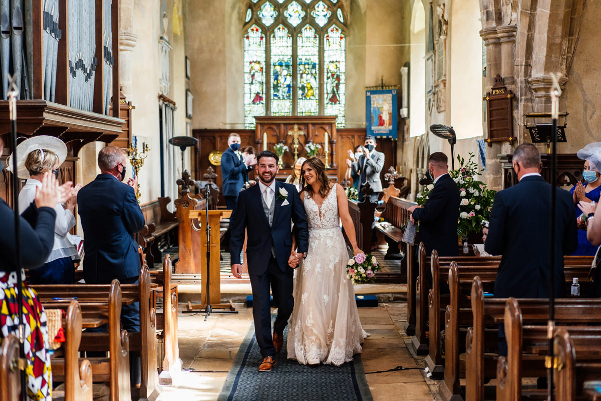 Bride and groom leave the church as husband and wife
