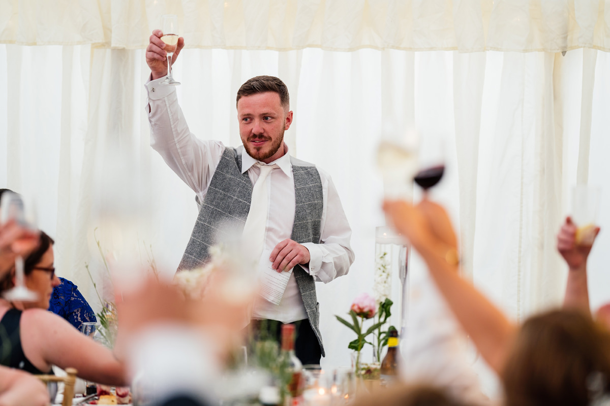 Best Man raises his glass and toasts the bride and groom
