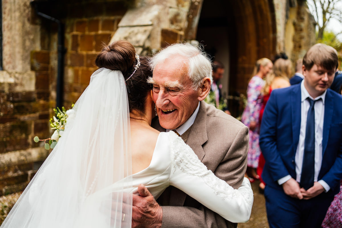 grandfather hugs the bride following the ceremony
