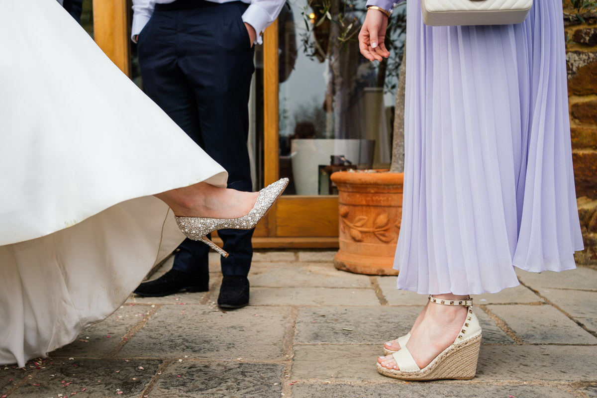 bride showing off her wedding shoes