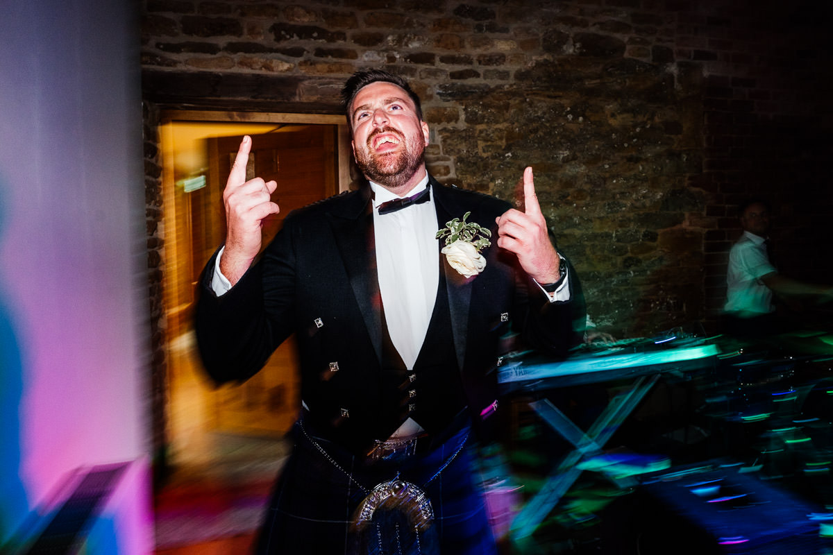 Best man throwing shapes on the dance floor