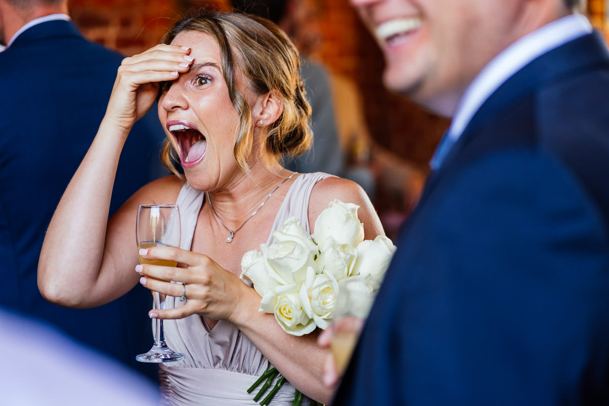 bridesmaid laughing during the drinks reception
