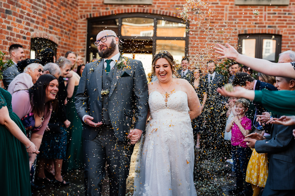 bride and groom being showered with confetti