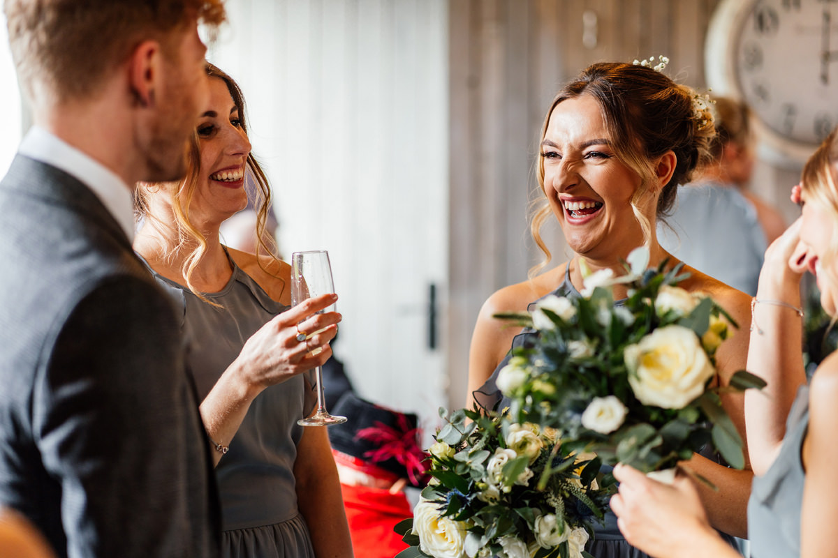 bridesmaids laughing with guests during the drinks reception