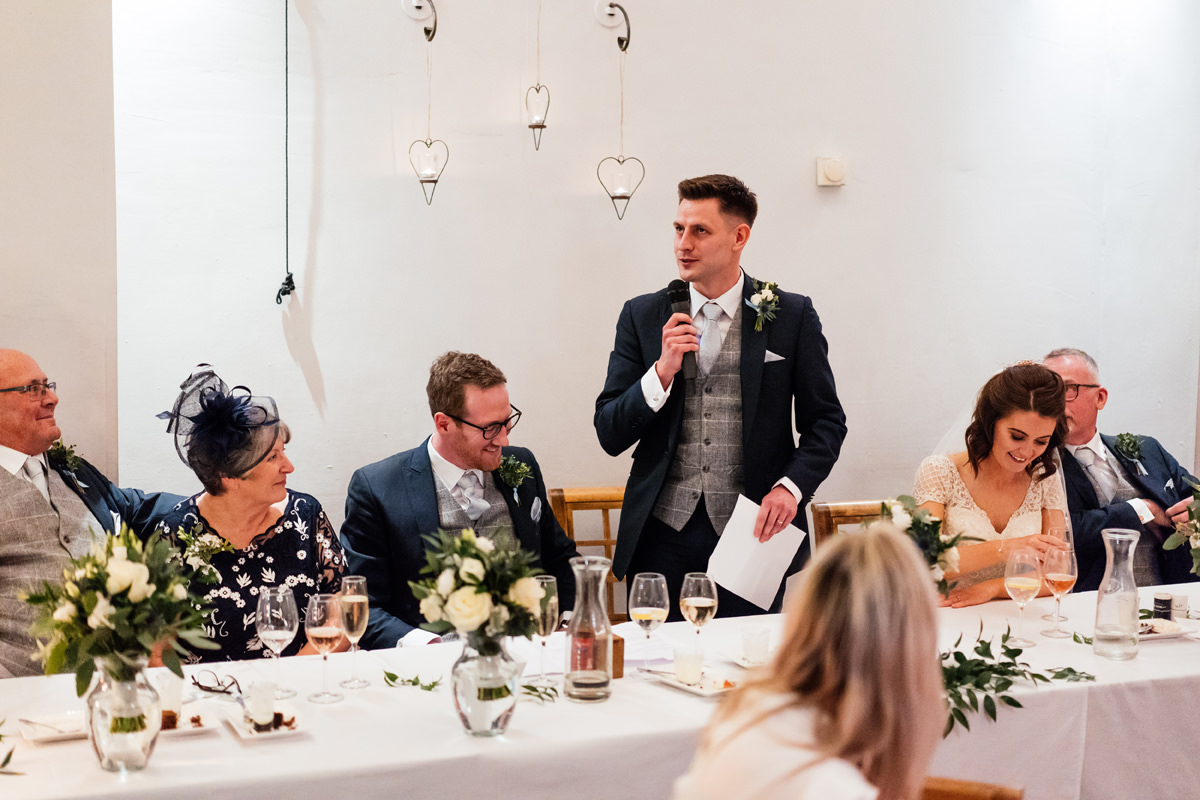 groom giving his speech at the top table