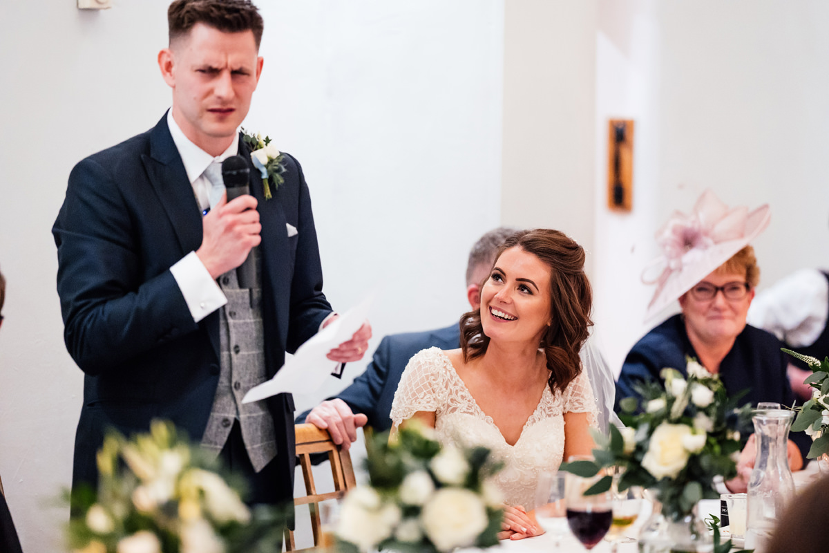 bride laughing at the groom's speech