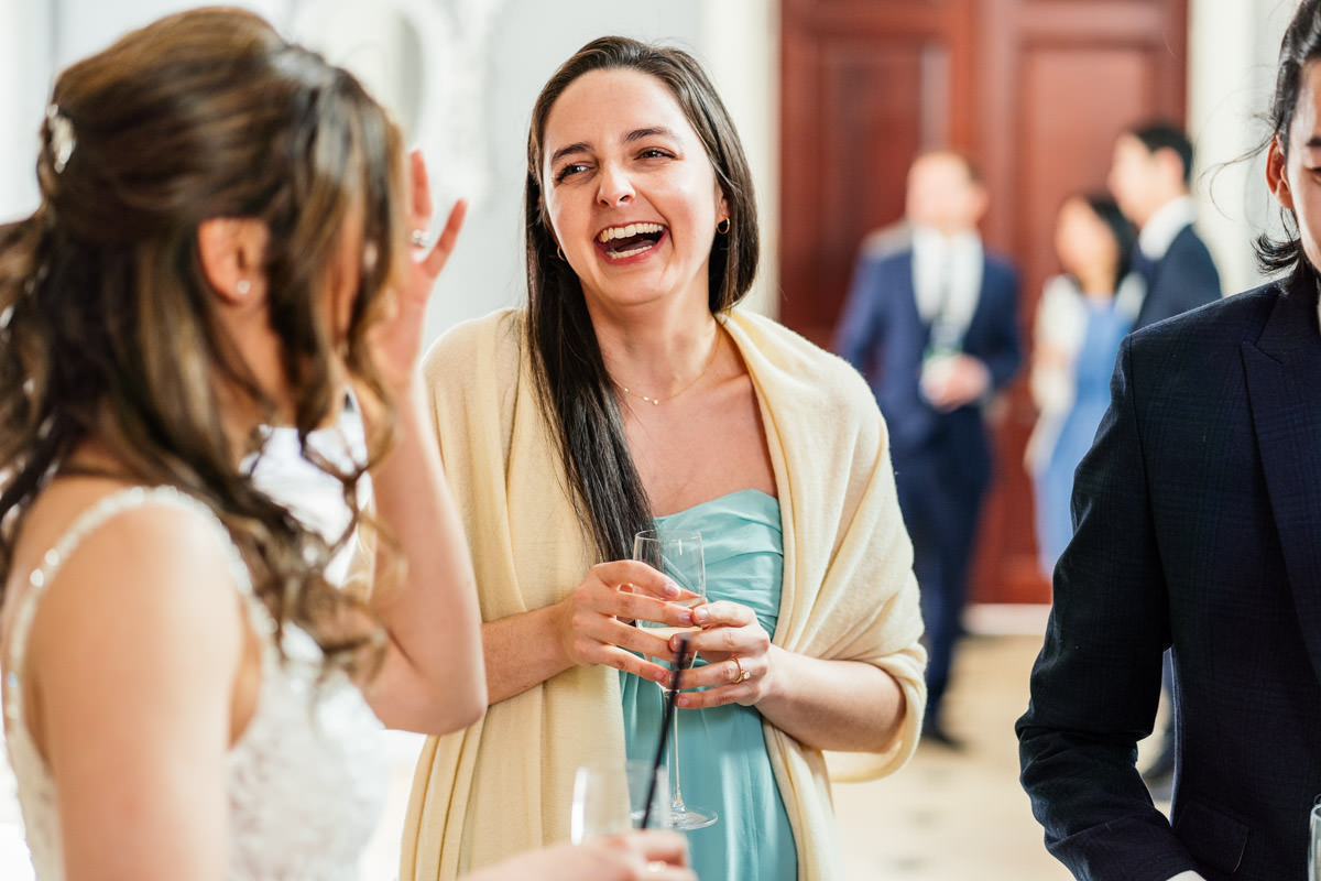 friends laughing during drinks reception