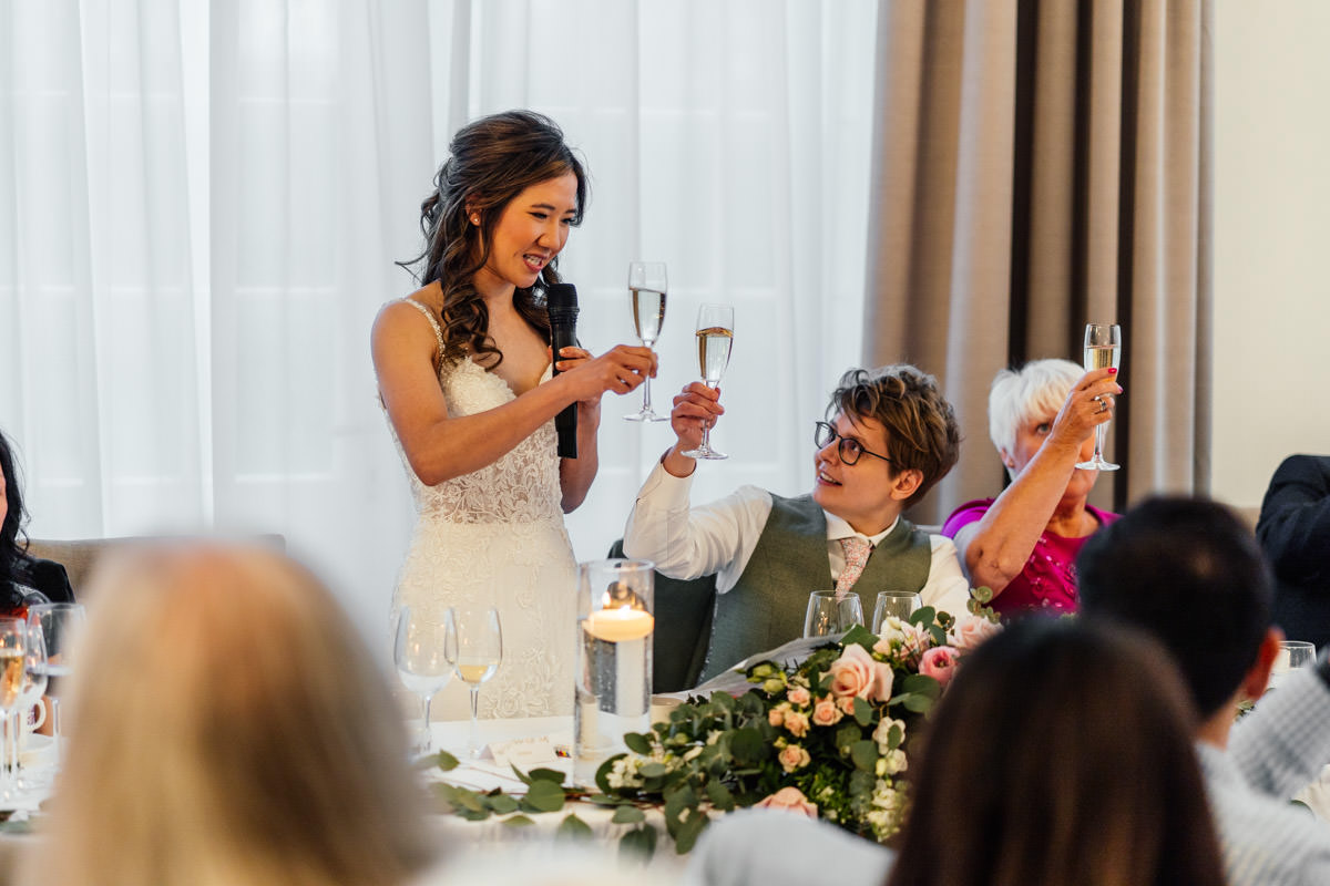brides toasting each other during the wedding speeches