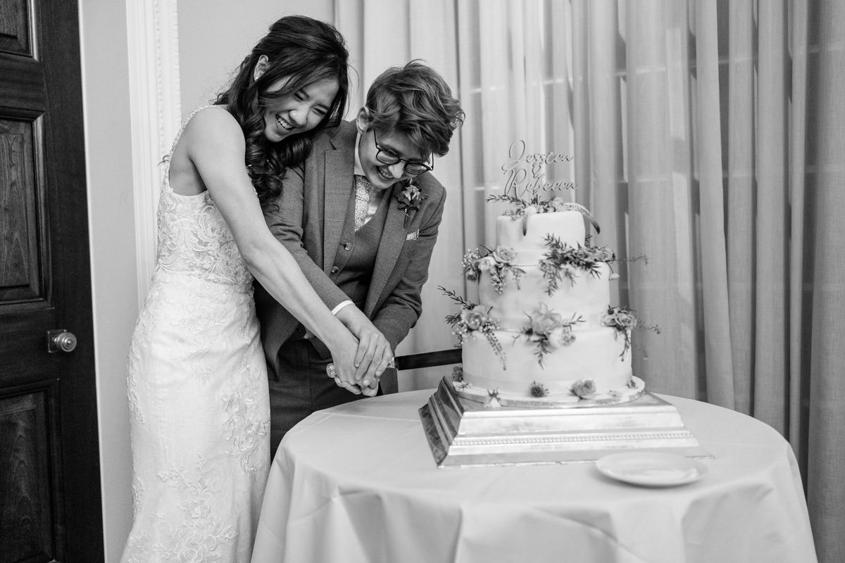 brides cut their wedding cake