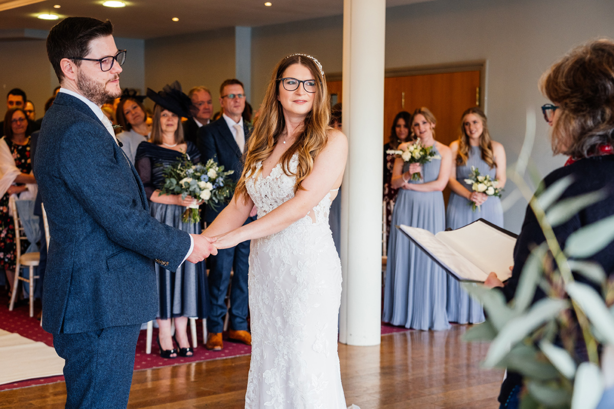 bride and groom exchange vows at Lake Vyrnwy Hotel Wedding