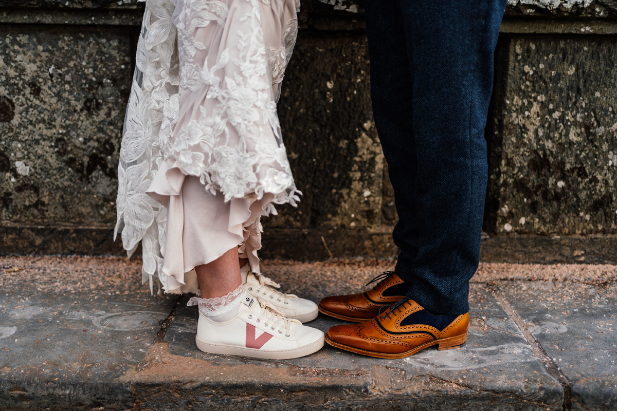 Bride's shoes are trainers and the groom has Church's brown leather shoes