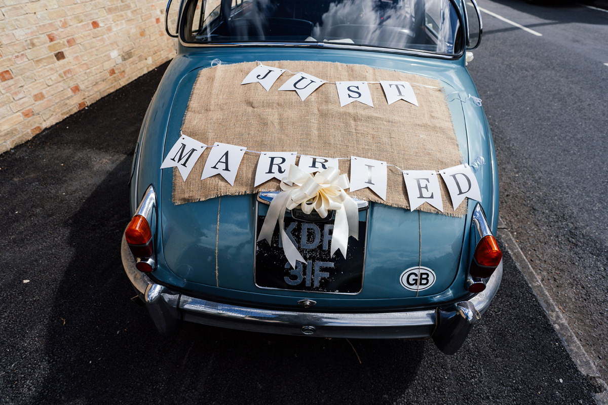 vintage jaguar wedding car with Just Married signage on the back