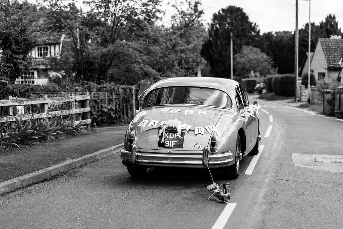 vintage jaguar drives the bride and groom to the wedding reception