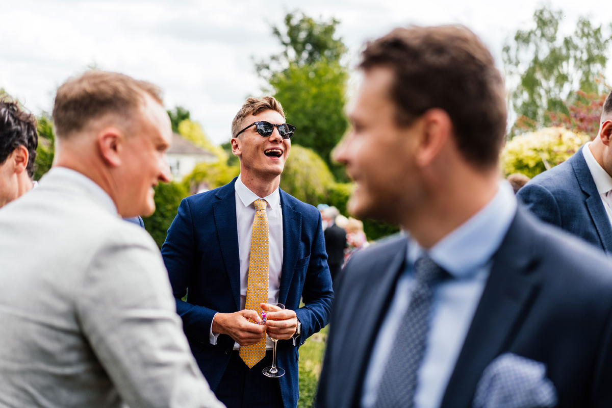 wedding guests laughing during the drinks reception