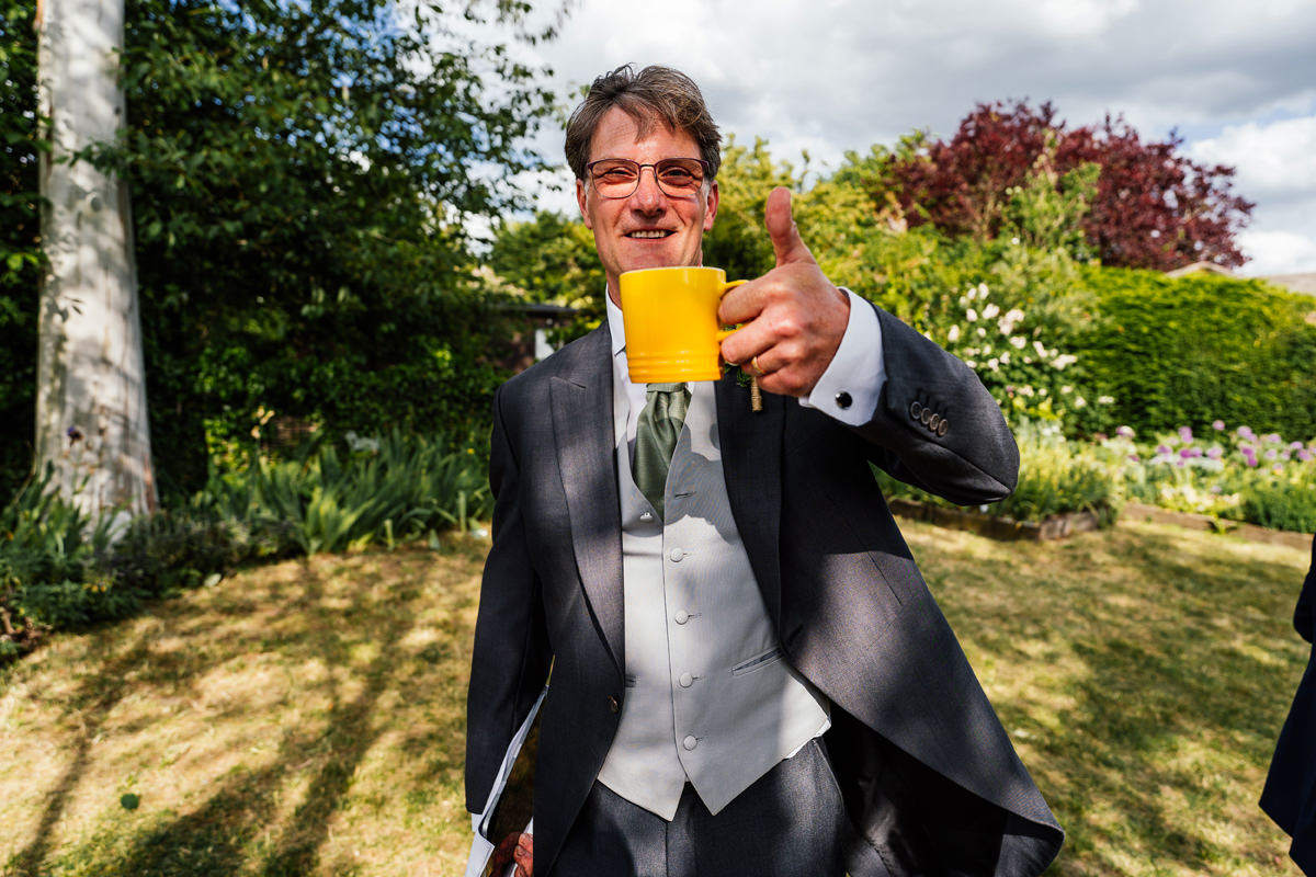 father of the bride giving me a thumbs up with his mug of tea