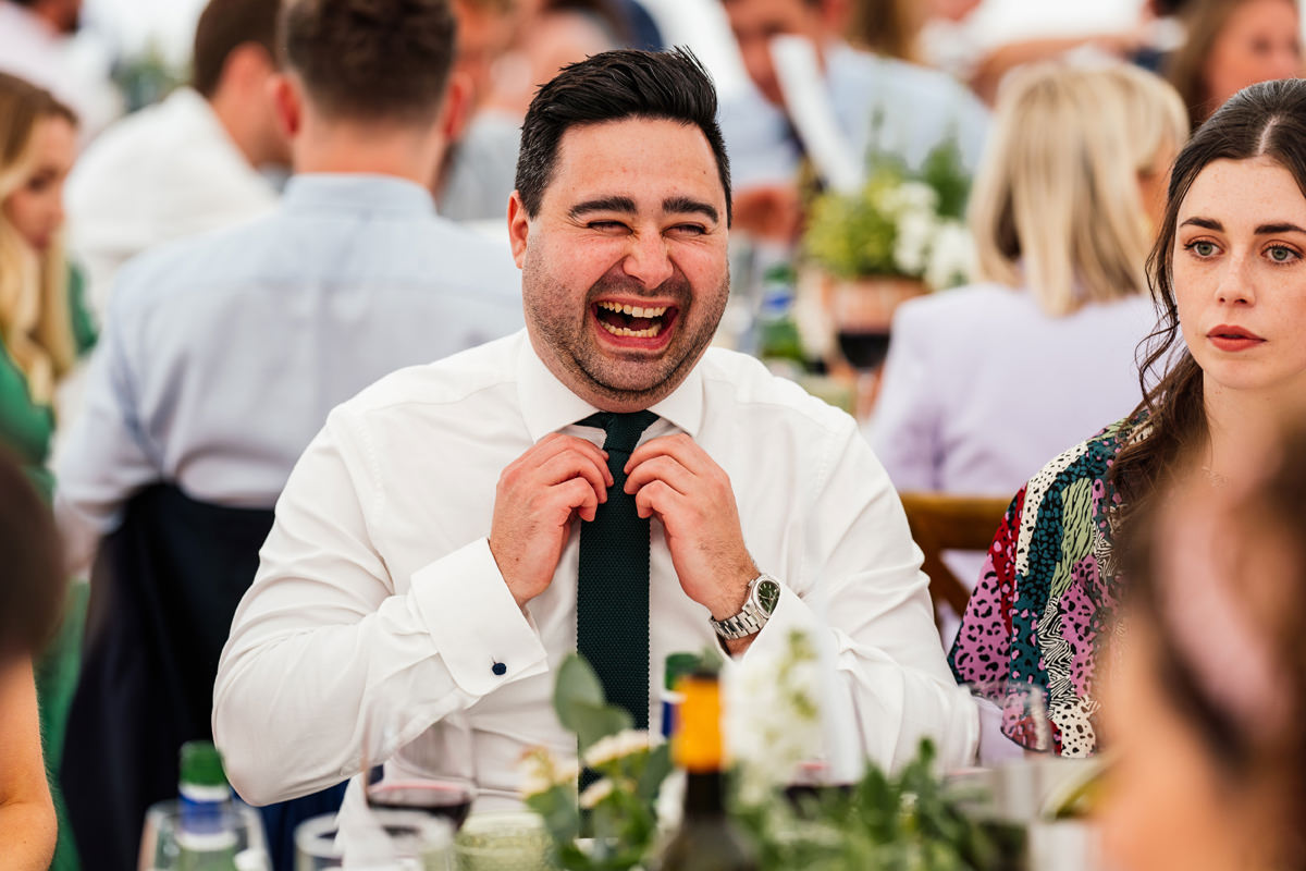 wedding guest laughing during the wedding breakfast and speeches