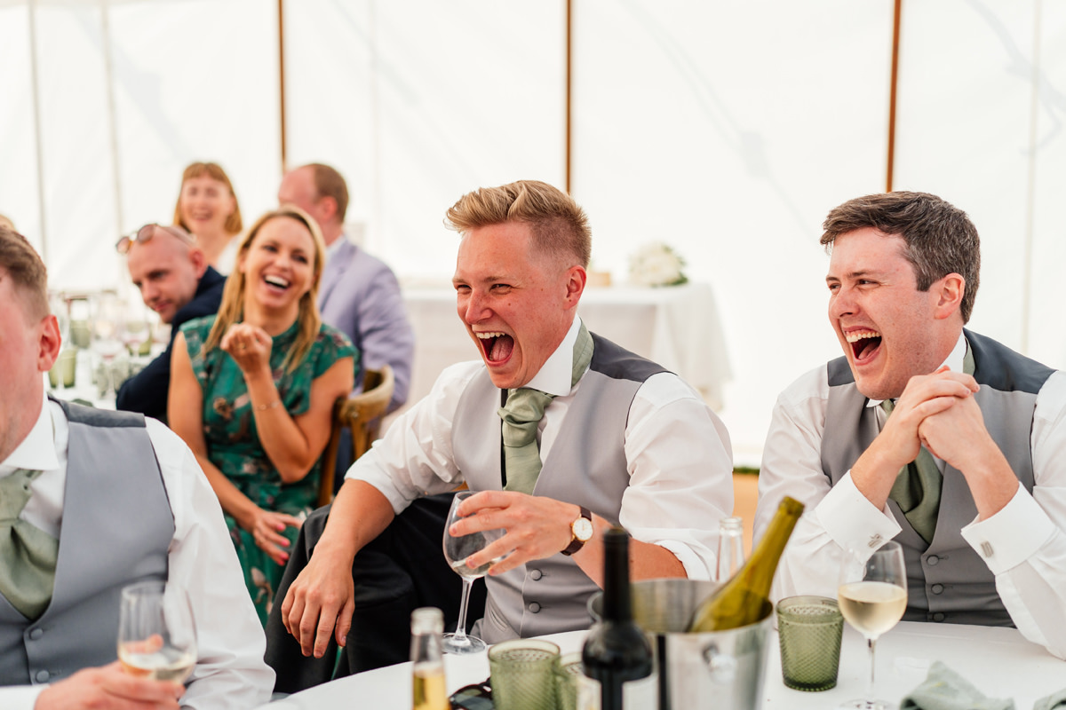groomsmen laughing during the speeches