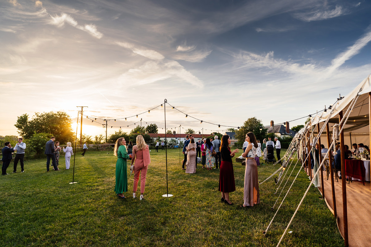 evening scene of guests mingling in the warm summer evening light