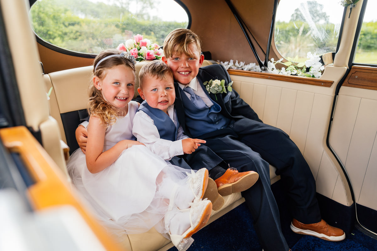 Kids sitting in the wedding car