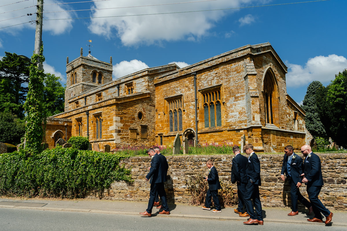 Groomsmen walking to Harpole Church