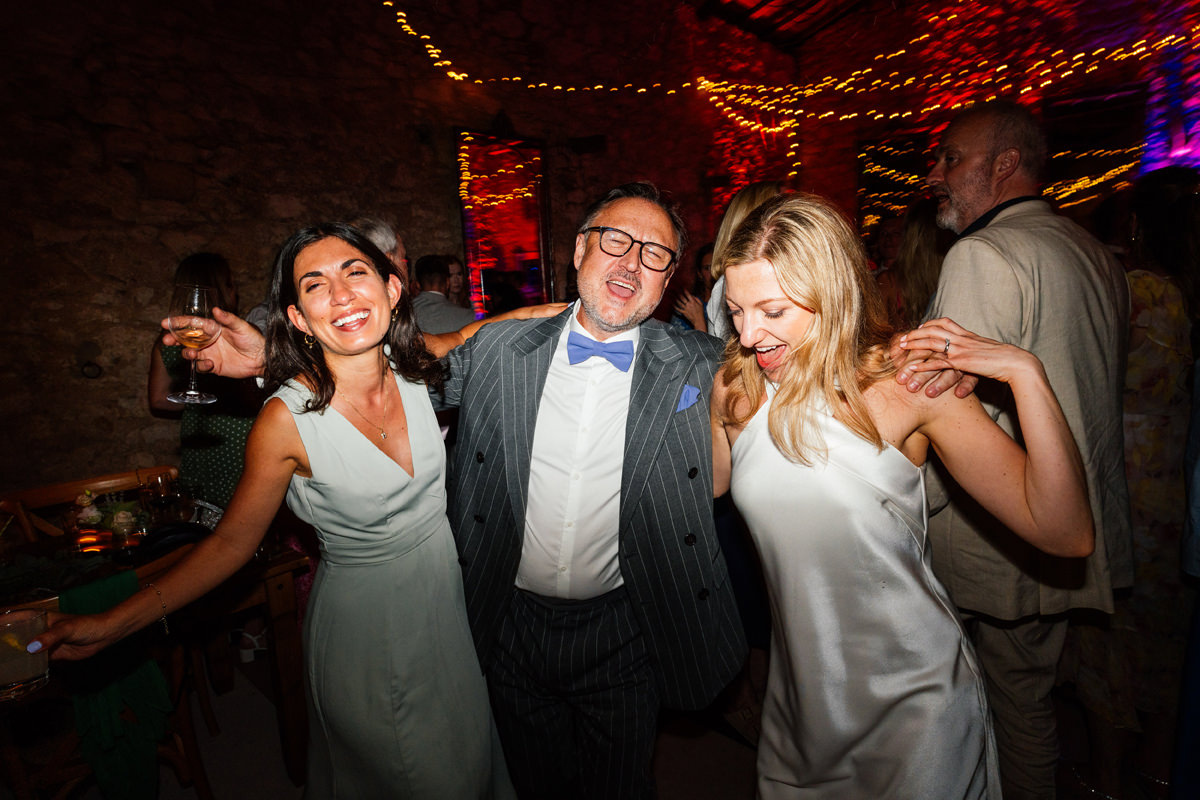 Bride's dad dancing with his daughter and one of the bridesmaids