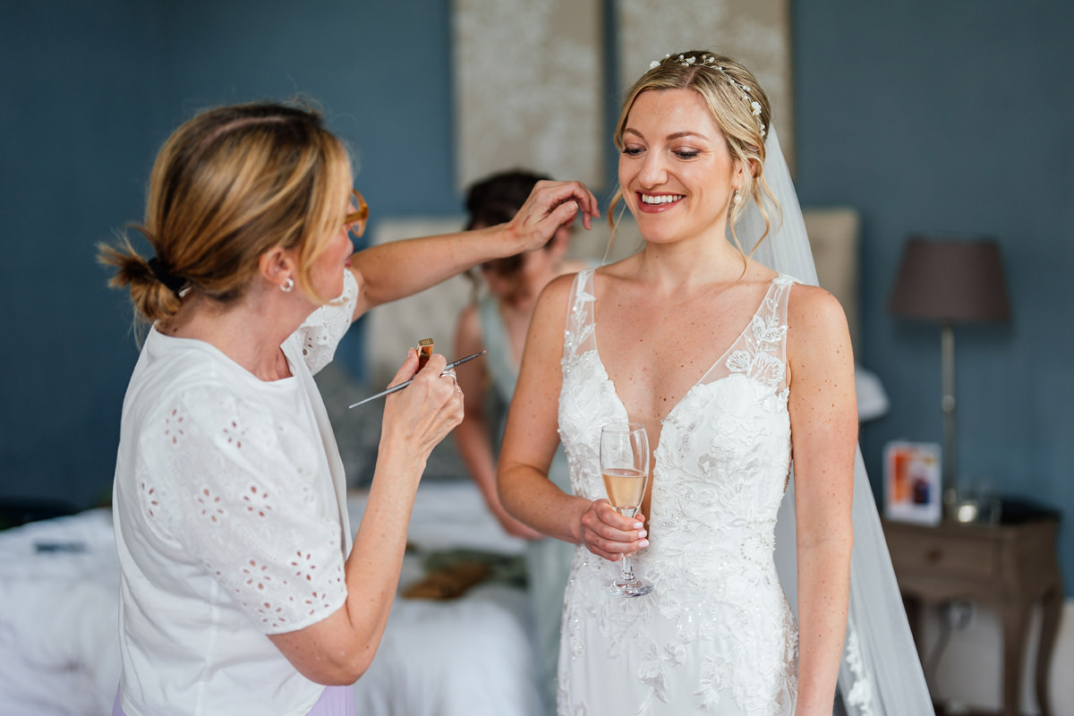 Final touches being made to the bride by make-up artist