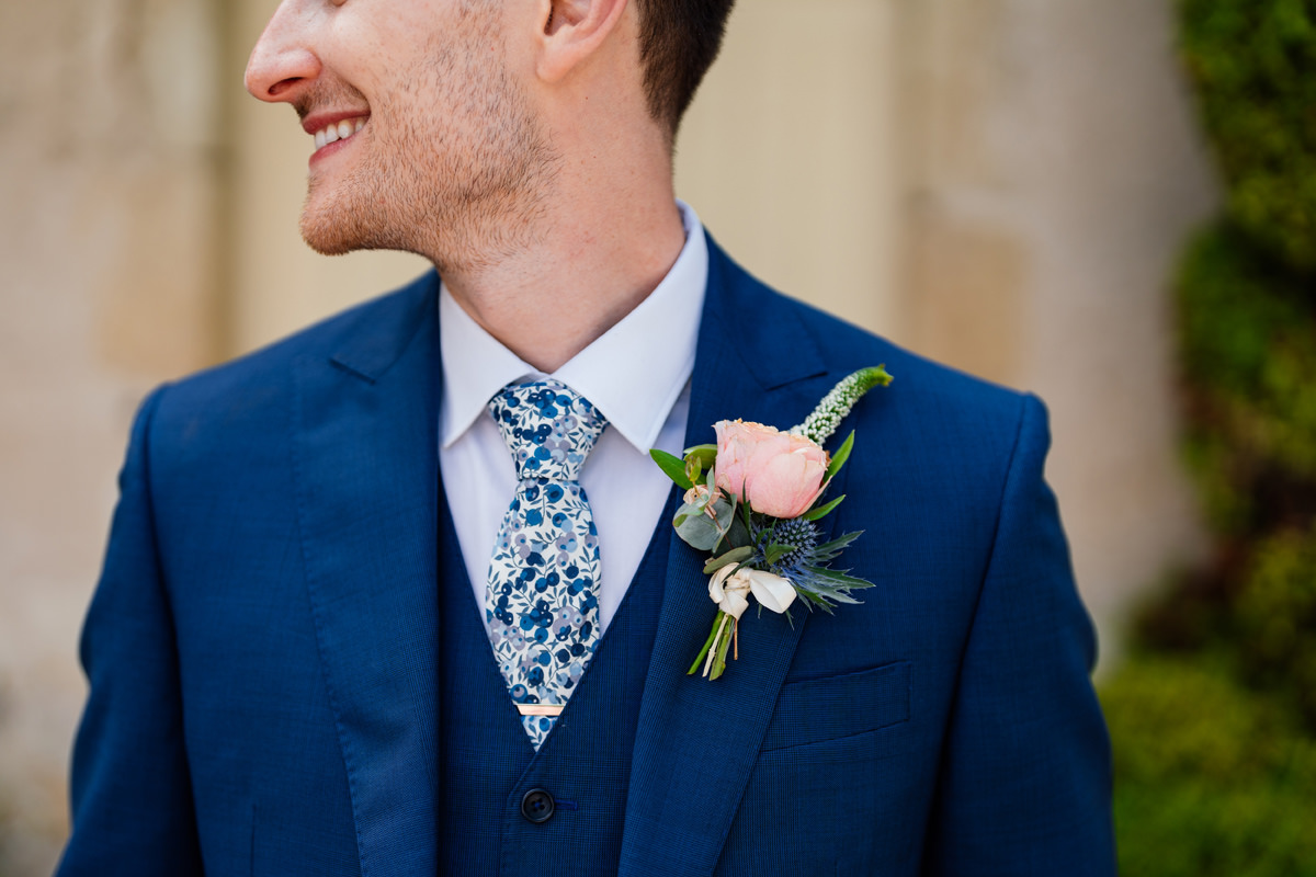 Groom details at Chateau Soulac wedding. Details of floral tie and button hole floral.