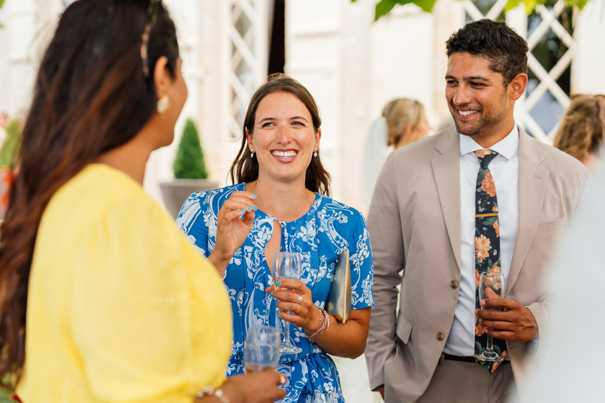 Wedding guests smiling and laughing during the drinks reception