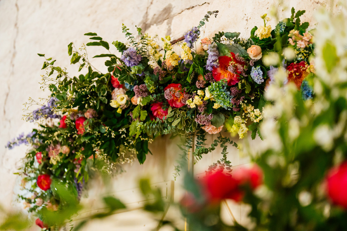 Colourful florals displayed in the ceremony barn