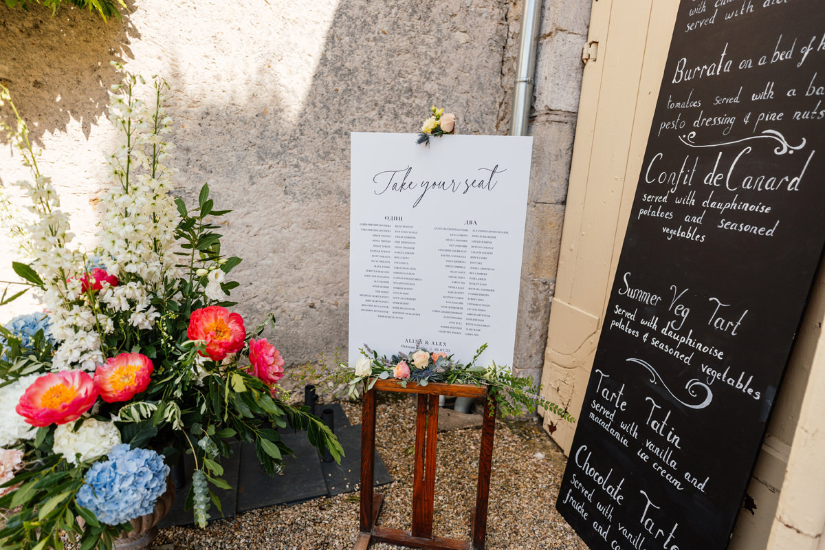 Flowers and table plan outside of the main barn at Chateau Soulac