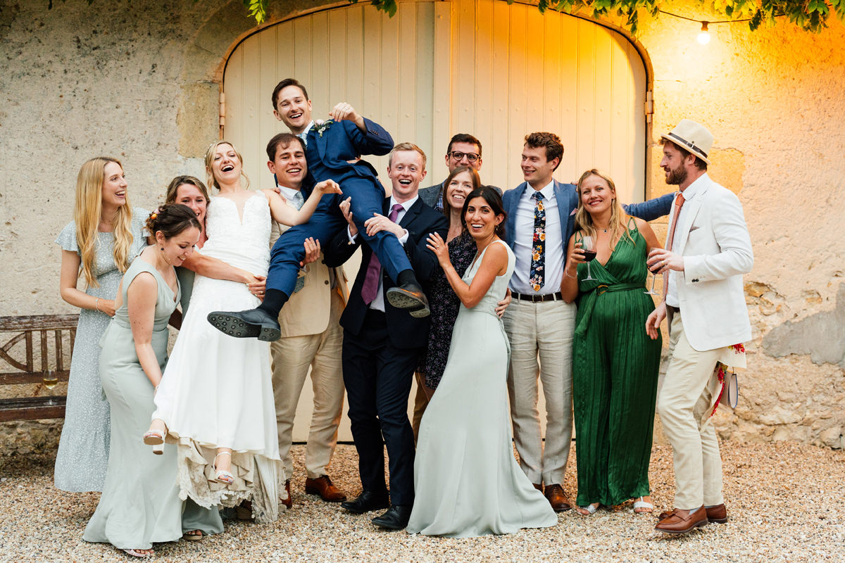 An informal group photo of bride and groom with friends
